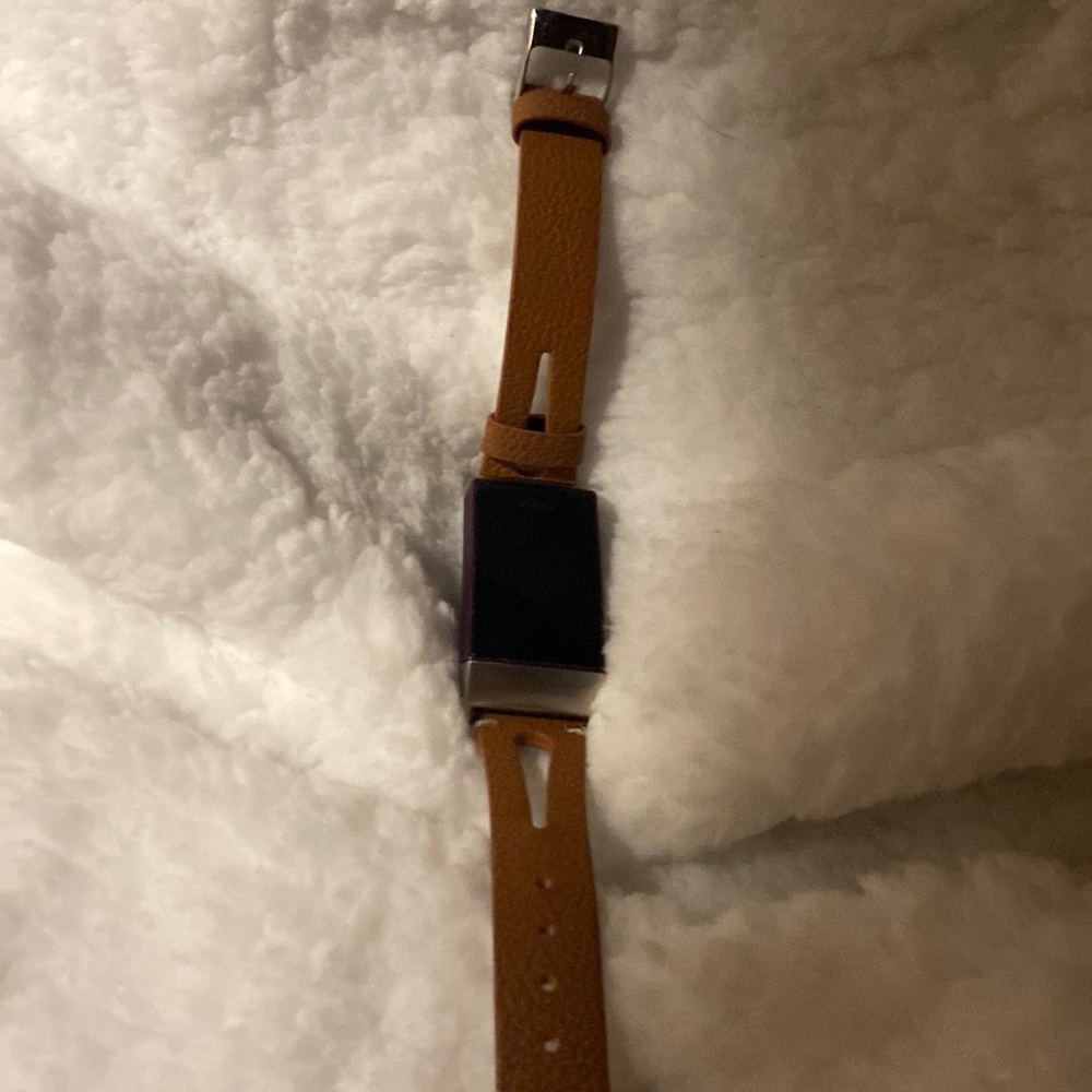 Fitbit charge 4 one black one purple and comes w three different bands